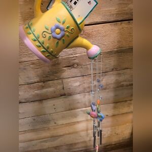 Wind chime featuring a watering pot-shaped top with floral accents